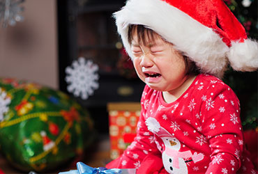 Girl in santa hat crying
