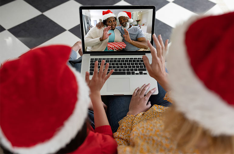 Two kids talking over the internet to family on Christmas